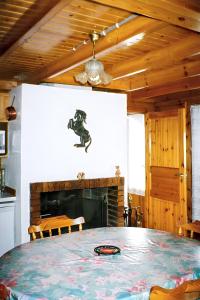 a dining room with a table and a fireplace at Chalet de 2 chambres avec terrasse amenagee a Sixt Fer a Cheval in Sixt