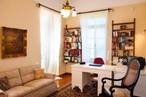 a living room with a desk and a couch at Villa Athina in Amaliás