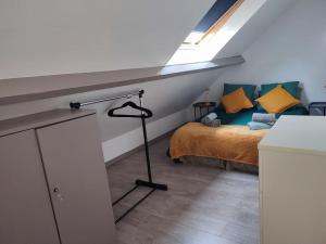 a bedroom with a bed in a attic at Le petit château in Pierrefonds