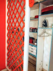 a kitchen with a red and blue partitioned closet at Appartement de 2 chambres avec jardin clos et wifi a Basse Terre in Basse-Terre