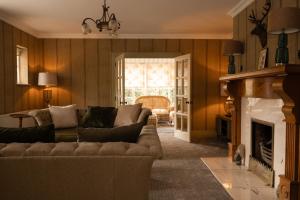 a living room with a couch and a fireplace at Galgorm in Ballymena