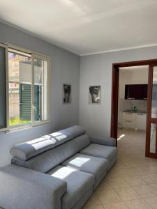 a living room with a couch and a window at Fun House in Trabia