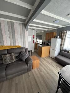 a living room with a couch and a kitchen at Seaside Escape Chalet in Bridlington in Bridlington