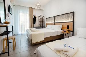 a hotel room with two beds and a desk at Ioanna's House in Potos