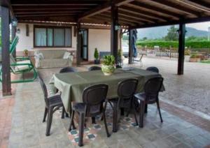 a green table and chairs on a patio at casa Maruzza in Casteldaccia