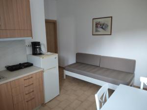a kitchen with a bench in the corner of a room at Protopapas in Palaiochora +8 photos