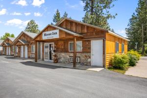 duży drewniany budynek ze stodołą dla koni w obiekcie Moose Inn w mieście Spirit Lake