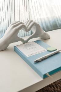 a book with a hand forming a heart on a table at Casa Maja in Costa de Antigua +22 photos
