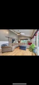 a living room with couches and a ceiling fan at Spacious Mountainside Home In Jackson Incredible Views, Hot Tub, Pet Friendly in Jackson