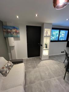 a living room with a couch and a black door at Le Petit Canaille in Cassis +16 photos