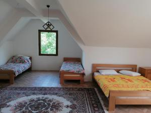 a bedroom with two beds and a rug at Pelister Riverside Villa in Bitola