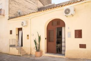 an entry to a building with a door and a plant at Meg Sicily House in Castellammare del Golfo