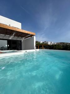 a swimming pool on the roof of a house at Villa Agrabely & Suites in Galanádhon