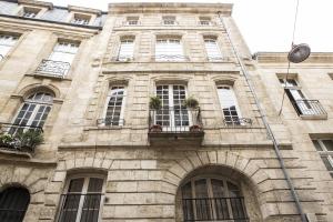 a stone building with windows and plants on it at Descazeaux in Bordeaux