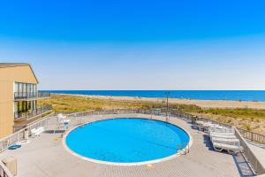 a view of a swimming pool and the beach at Sea Colony Farragut House III in Bethany Beach