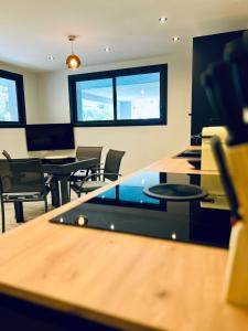 an empty office with tables and chairs and windows at Le Petit Canaille in Cassis