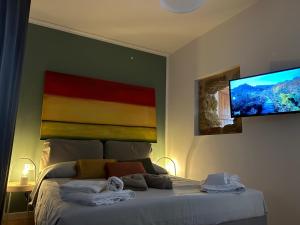 a bedroom with a bed with towels on it at Baglio San Giovanni in Palermo