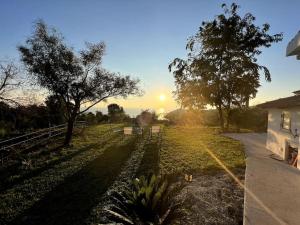 a view of a field with the sunset in the background at Villetta Suite indipendente in Santa Maria