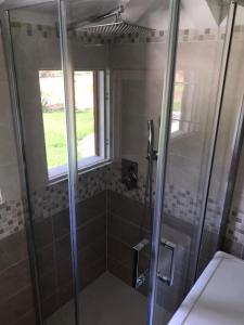a shower with a glass door in a bathroom at Villetta Suite indipendente in Santa Maria