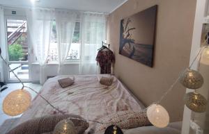 a bedroom with a bed in a room with a window at Ortopla Terrace Apartment Stinica in Stinica
