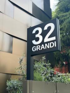 a sign in front of a building that says grand at Grandi 32 in Segrate