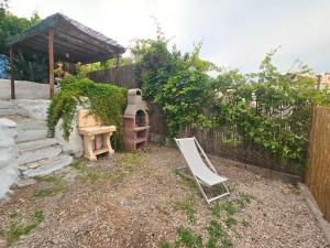 a chair sitting in a yard with a stove at Maridea - Marlin in Ponza