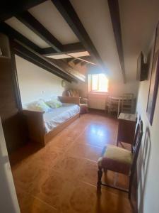 a bedroom with a bed and a chair in a room at Alojamiento Rural Monterey in La Revilla