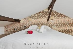 a bedroom with a white bed with a rose on it at KAZA BELLA - Maisons Alfort 4 Modern renovated bright apartment in Maisons-Alfort