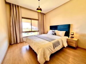 a bedroom with a large bed and a window at Best appartement for relaxation Prestigia in Marrakesh