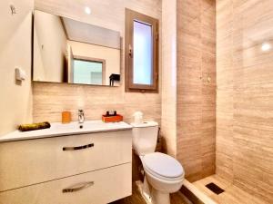 a bathroom with a toilet and a sink and a mirror at Best appartement for relaxation Prestigia in Marrakesh