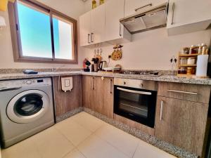 a kitchen with a washer and a washing machine at Best appartement for relaxation Prestigia in Marrakesh