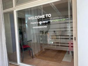 a window of a store with a welcome sign on it at Frank’s house 41 Underground in Cavallino di Lecce