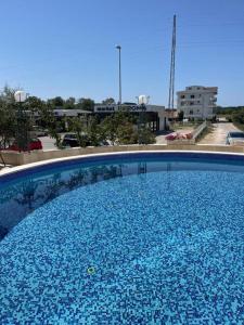 a large blue swimming pool in a city at Imperial Hotel in Ulcinj