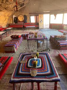 a room with a rug on the floor with tables at Sunlover Camp in Disah