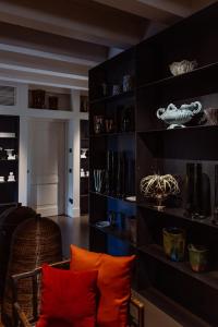 a living room with black shelves and orange pillows at Casa TOMA - Luxury Garden House in Arzignano +180 photos