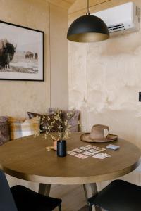 a dining room table with a hat on top of it at Yellowstone Peaks Hotel in Island Park