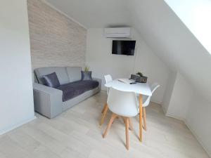 a living room with a couch and a table at Apartments in Green House in Bovec