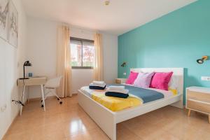 a bedroom with a bed and a desk in it at Casa Emma in Corralejo