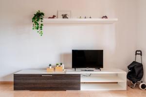 a living room with a tv on a white table at Casa Emma in Corralejo