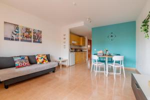 a living room with a couch and a table at Casa Emma in Corralejo