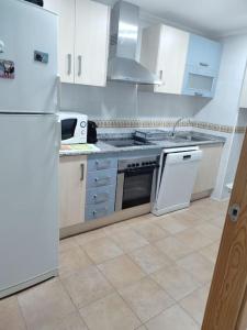 a kitchen with white appliances and a white refrigerator at Apartment Cala Dor in El Campello