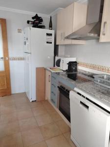 a kitchen with white appliances and a white refrigerator at Apartment Cala Dor in El Campello