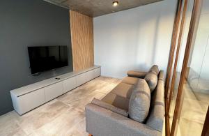 a living room with a couch and a flat screen tv at Urban Rent - Departamentos Temporarios en Belgrano in Buenos Aires