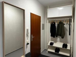 una cabina armadio con porta e vestiti di Ferienwohnung Mia a Niestetal