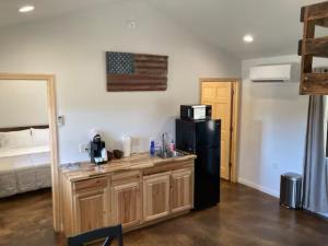 a kitchen with a sink and a refrigerator in a room at Gold Valley Camp Cabin 2 in Custer