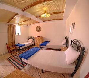 a living room with two beds and a couch at Riptide Surf House in Taghazout