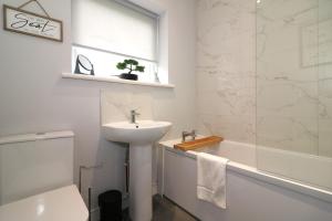 a bathroom with a sink and a toilet and a shower at Signature - Huntley House in Glasgow +37 photos