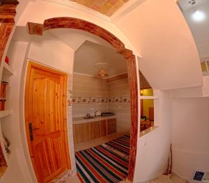 a room with a hallway with a door and a rug at Riptide Surf House in Taghazout