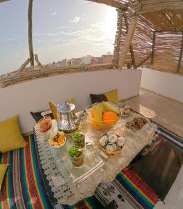 a table with a tray of food on a balcony at Riptide Surf House in Taghazout