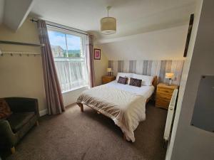 a bedroom with a bed and a large window at Valley Bar in Scarborough